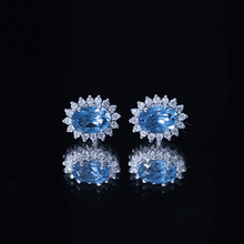 Load image into Gallery viewer, 1.6 Carat Oval London Blue Topaz Stud Earrings with Diamond Halo