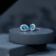 Load image into Gallery viewer, 1.6 Carat Oval London Blue Topaz Stud Earrings with Diamond Halo