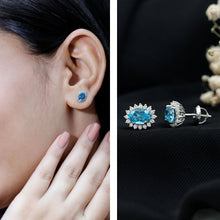 Load image into Gallery viewer, 1.6 Carat Oval London Blue Topaz Stud Earrings with Diamond Halo