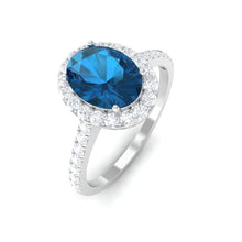 Load image into Gallery viewer, 2 CT Oval Cut London Blue Topaz Solitaire Ring with Diamond Halo